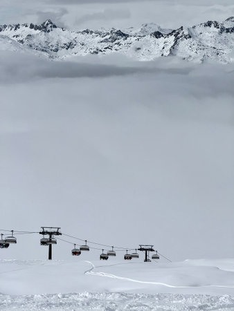 View of sunny winter in dolomites, alps. Madonna di Campiglio village covered in fog and clouds a ski resort in Italy. Madonna di Campiglio ursus snowpark in Val Rendena dolomites trentino Italy.の写真素材