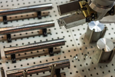 The robot arm places pins and shafts on a pallet. Production automation. Robotic inspection arm...