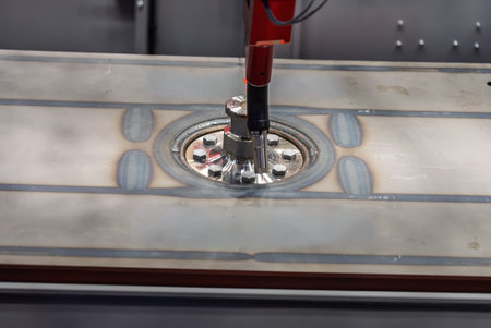 Robot welds steel. Welding head. Weld robot. CNC welding. Robotization and automation of the weld process. Robot welding steel. Industrial welding robot and working with metal parts.の写真素材