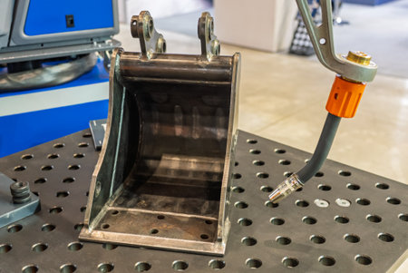 Robot welds steel. Welding head. Weld robot. CNC welding. Robotization and automation of the weld...