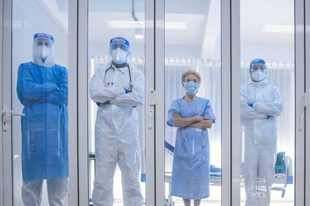 Dortor, Nurse and patient looking out in the quarantine room from case of coronavirus covid 19....