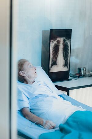 Medical team take to female patient coronavirus or COVID19 and try to give medicine to her in the quarantine room.の写真素材