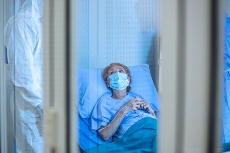 Hopeless mood on Infected covid19 patient during lying on bed at quarantine room area in hospital. Case from coronavirus covid 19 disease. Corona virus is world global social issue concept.の写真素材