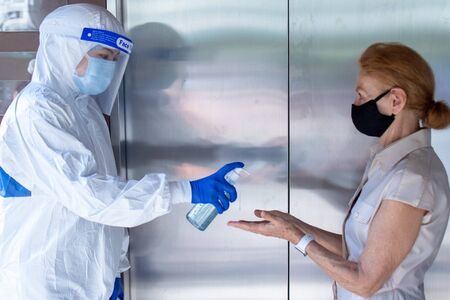 Social Distancing on Elevator with passenger stand in the corner from outbreak of coronavirus covid19 situation. Concept of aware safe and low risk.の写真素材