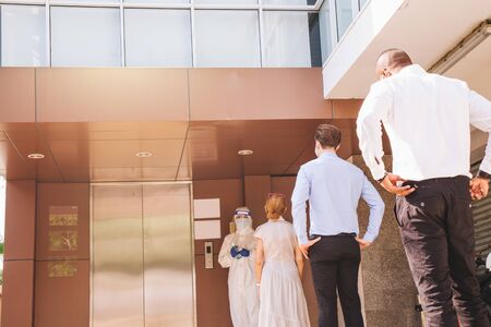 Social Distancing on Elevator with 4 passengers stand in the corner from outbreak of coronavirus...