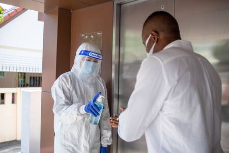 Officer Squeezing gel to people hands for wash hand by sanitizer gel dispenser, against Novel...
