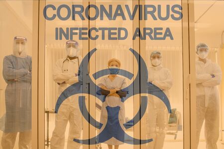 Medical team with background of coronavirus sign in the quarantine room