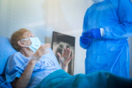 Old woman patient is in state quarantine from coronavirus covid19 outbreak and stay in the quarantine room.の写真素材