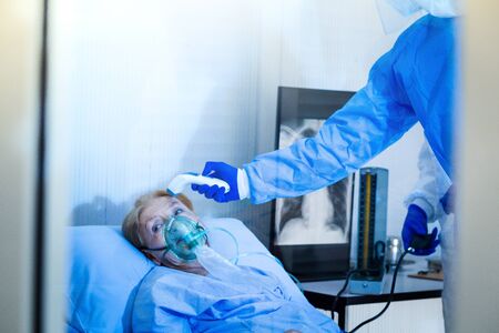 Old woman patient is in state quarantine from coronavirus covid19 outbreak and stay in the quarantine room.の写真素材