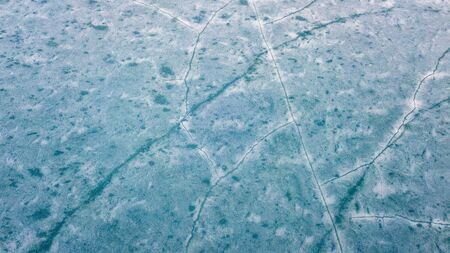 Blue Ice surface of Frozen Lake from drone aerial view at Pangong Lake or Pangong Tso, Tso moriri...