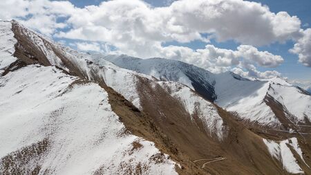 Natural Atmosphere of Leh Ladakh City, Jammu, north of India in Winter. Rock Mountain with Snow cover to Himalayas mountains, one of Highest road in the world. Photo from aerial view by drone.の写真素材