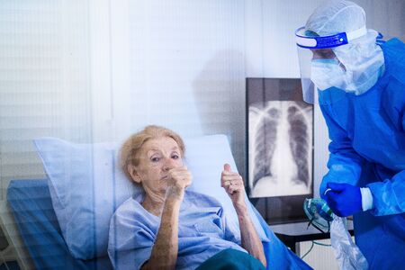 Infected patient on takecare of Doctor and nurse with x-ray Lung in quarantine lying on bed in...