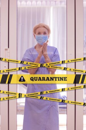 Old patient has been infected on coronavirus covid19 contagious disease and state quarantine in the quarantine room in hospital with under take care of medical team.の写真素材