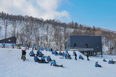 Area of Kiroro ski resort. Skiers and Snowboarders Ride the Gondola at Kiroro Ski Resort during winter with fully of snow ground in Hokkaido, Japan.の写真素材