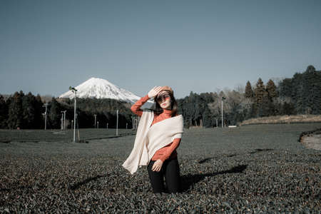 Pretty woman standing in the middle of the tea tree with Fuji Mountian view in Fujinomiya, Shizuoka. Shizuoka is one of the best natural on Tea in the world.の写真素材