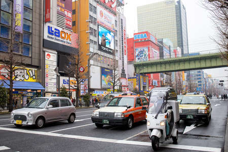 Tokyo, Japan - February 2020: Neon lights and billboard advertisements on buildings at Akihabara at rainy night. Akihabara is a shopping district for video games, anime, manga, and computer goods.のeditorial素材
