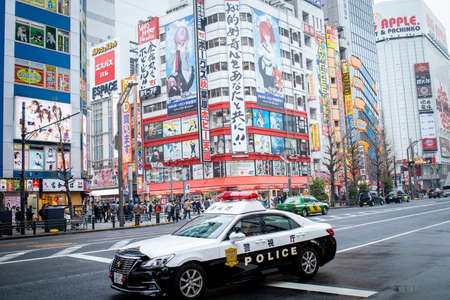 Tokyo, Japan - February 2020: Neon lights and billboard advertisements on buildings at Akihabara at rainy night. Akihabara is a shopping district for video games, anime, manga, and computer goods.のeditorial素材