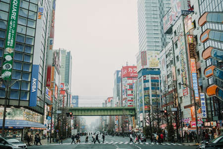 Tokyo, Japan - February 2020: Neon lights and billboard advertisements on buildings at Akihabara at rainy night. Akihabara is a shopping district for video games, anime, manga, and computer goods.のeditorial素材