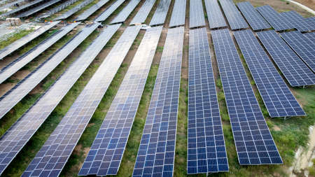 Aerial view over a modern solar farm. Solar panels station for collect green energy on concept of global ecosystem.の写真素材