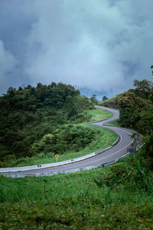 Road no.3 or sky road on Root 1081 over top of mountains with green jungle in Santisuk - Bo Kluea District, Nan province, Thailand.の写真素材
