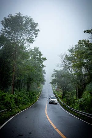 Sky Road way to the misty world on background of 1715 road, Nan, Thiland with full of mist fog during rainy season.のeditorial素材