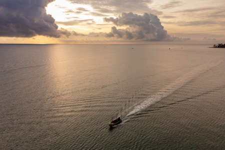 Sichon beach, Thailand - November 2021 : Aerial bird eyes view of Unidentified jet ski inclouding banana boat behide cruising in high speed in turquoise clear water sea.のeditorial素材