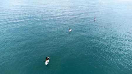 Gulf of Thailand - Ocotber 2021 : Unidentified two men on sea Kayaker Aerial View. Caucasian Sportsman in the Yellow and Blue Kayak Paddling on the Scenic sea Along the Shore.のeditorial素材