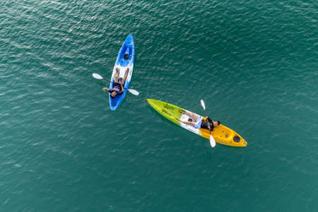 Gulf of Thailand - Ocotber 2021 : Unidentified two men on sea Kayaker Aerial View. Caucasian Sportsman in the Yellow and Blue Kayak Paddling on the Scenic sea Along the Shore.のeditorial素材