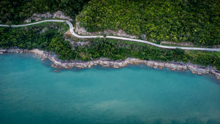 Ocean Road and sand beach in Khanom Sichon Road at Khao Phlai Dam, Nakorn Sri Thammarat province, Thailand. Shot by Drone Aerial Viewの写真素材