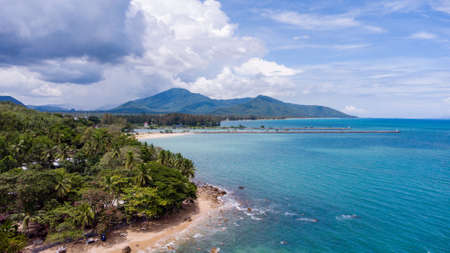 Aerial view of clear turquoise sea on sandy beach and ocean with waves.