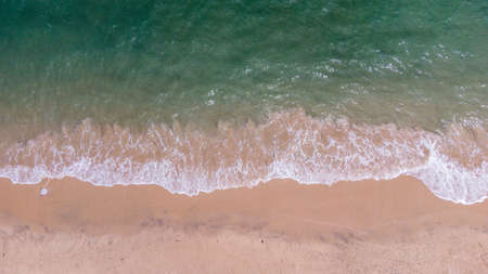 Aerial view of clear turquoise sea on sandy beach and ocean with waves.の写真素材