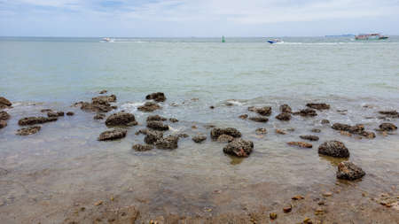 Rock coast with blue sea at Balihai area, Pattaya, Thailand.の写真素材