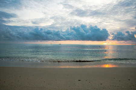 View of the clear sky on the sea and there was a big cloud with background of the sunriseの写真素材