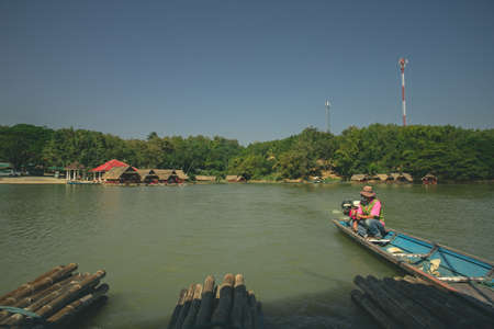 Loei Province, Thailand - December 2021 : Area of Huai Krathing reservoir with bamboo raft shelter for Rafting and Eating. Beautiful natural landscape of the river and mountain with blue skyのeditorial素材