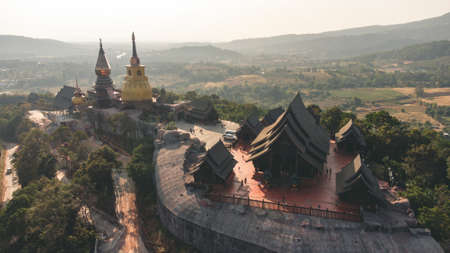 Wat Somdet Phu Ruea Ming Mueang Temple fly over aerial view. Temple is built with fine wood timber. The church is made of teak and locate on mountain and best viewpoint at Phu ruea, Loei, Thailandの写真素材