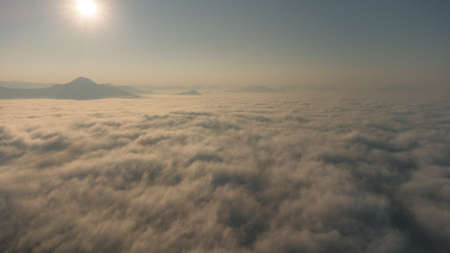 Sea of Fog covers the area on the top of hill Doi Phu Thok, Chiang Khan, Loei, Thailand with background of sunrise on winter.の写真素材