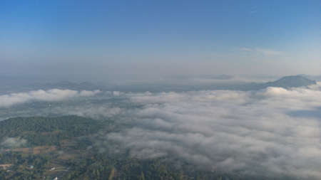 Sea of Fog covers the area on the top of hill Doi Phu Thok, Chiang Khan, Loei, Thailand with background of sunrise on winter.の写真素材