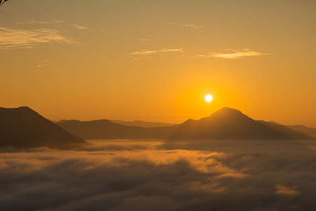Sea Fog and Golden sunrise covers the area on the top of hill Doi Phu Thok, Chiang Khan, Loei, Thailand with background of sunrise on winter.の写真素材