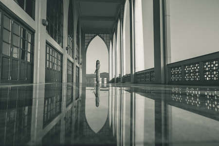 Lady in silhoette in area of Central Mosque in Songkhla province, Southern of Thailand. Photo reflection of shadow by polished floorの写真素材