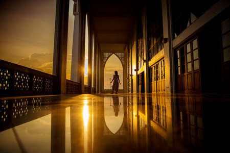 Lady in silhoette in area of Central Mosque in Songkhla province, Southern of Thailand. Photo reflection of shadow by polished floorの写真素材
