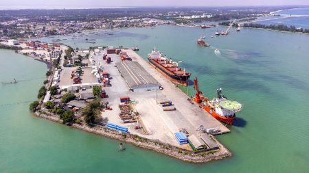 Songkhla island, Thailand - February 2022 : Aerial view of transportation industrial shipping business and cargo ship container. Located on a peninsula that separates the estuary.のeditorial素材