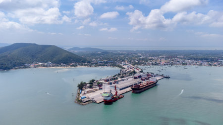 Songkhla island, Thailand - February 2022 : Aerial view of transportation industrial shipping business and cargo ship container. Located on a peninsula that separates the estuary.のeditorial素材