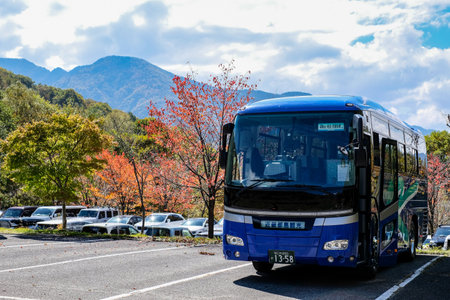 Kamikochi, Nagano, Japan - October 2022 : Unidentified tourists bus with a beautiful background of Fall foliage season in Japan alps.のeditorial素材