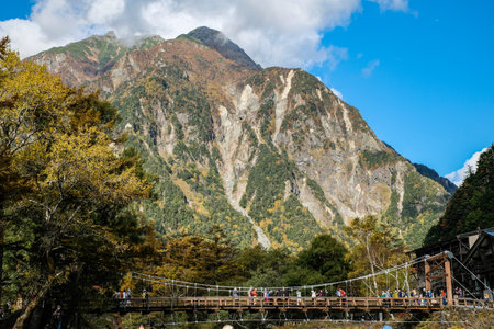 Kappa bashi Bridge, Kamikochi national park, Nagano, Japan - October 2022: Kamikochi during Fall Foliage season with beautiful nature on snow mountain and Leaf change from green toのeditorial素材