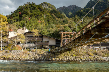 Kappa bashi Bridge, Kamikochi national park, Nagano, Japan - October 2022: Kamikochi during Fall Foliage season with beautiful nature on snow mountain and Leaf change from green toのeditorial素材
