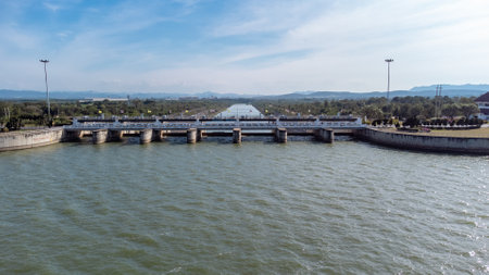 An aerial view over the Pasak Jolasid dam, Lopburi Province, Thailand. Tracking the movement of the floodgates that are releasing water into rural canals in enormous amounts of watの写真素材