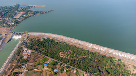 An aerial view over the Pasak Jolasid dam, Lopburi Province, Thailand. Tracking the movement of the floodgates that are releasing water into rural canals in enormous amounts of watの写真素材