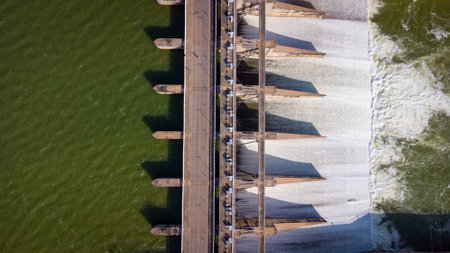 An aerial view over the Pasak Jolasid dam, Lopburi Province, Thailand. Tracking the movement of the floodgates that are releasing water into rural canals in enormous amounts of watの写真素材