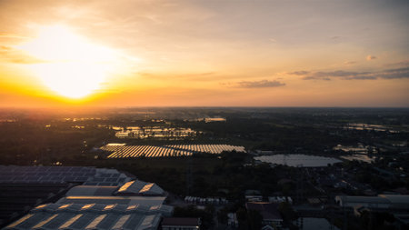 Fly over Solar cells on the roof of a large industrial factory. Solar roofs are generating renewable energy for the industry. The goal is to reduce the cost of electricity.の写真素材