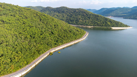 Muak Lek reservoir in Saraburi from aerial bird eye view. Beautiful unseen nature at Muak Lek dam with roadway beside with water and tree hill.の写真素材